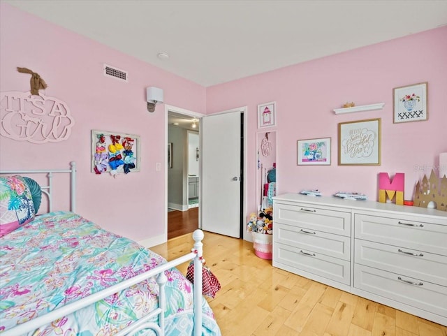 bedroom with light hardwood / wood-style floors