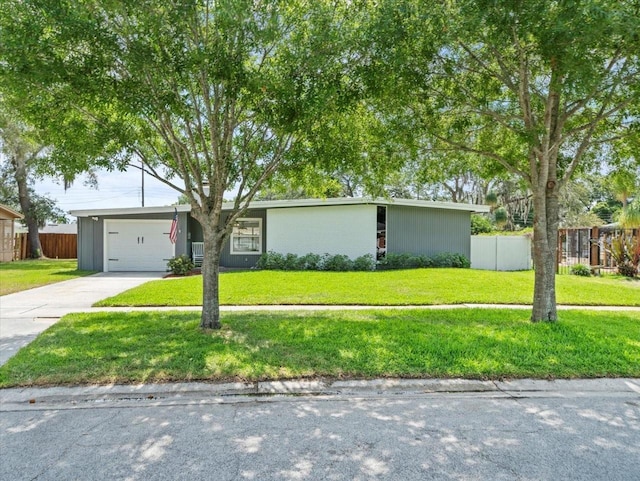 ranch-style home featuring a garage and a front yard