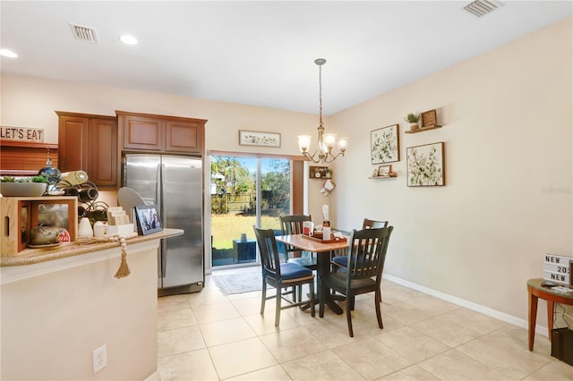 tiled dining area with a chandelier