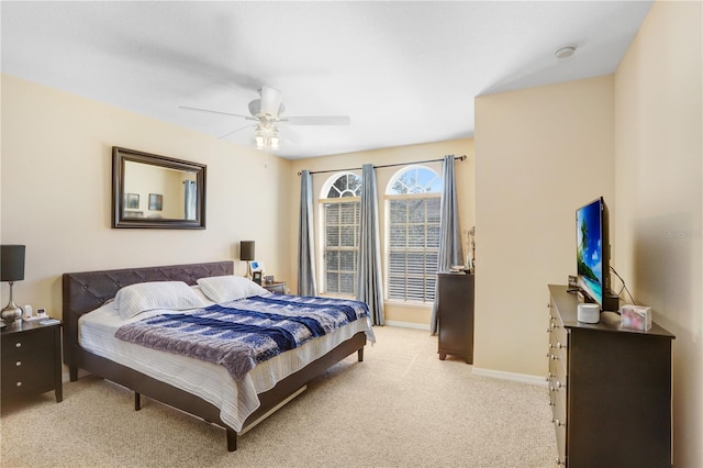 bedroom with light colored carpet and ceiling fan