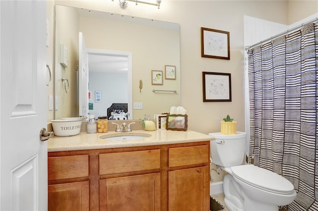 bathroom featuring vanity, toilet, and a shower with shower curtain