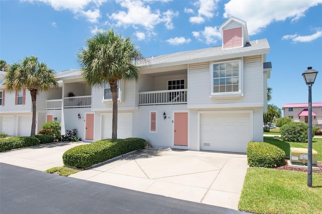 view of front of property with a balcony and a garage