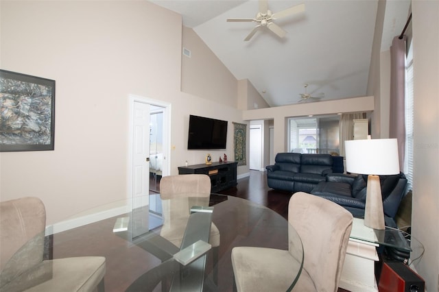 living room featuring dark wood-type flooring, ceiling fan, and high vaulted ceiling