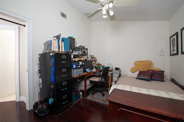 bedroom featuring wood-type flooring, ceiling fan, and a textured ceiling