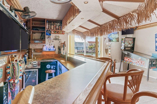 kitchen with wine cooler, a textured ceiling, and light tile patterned flooring