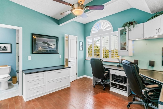 office with a textured ceiling, wood-type flooring, and ceiling fan