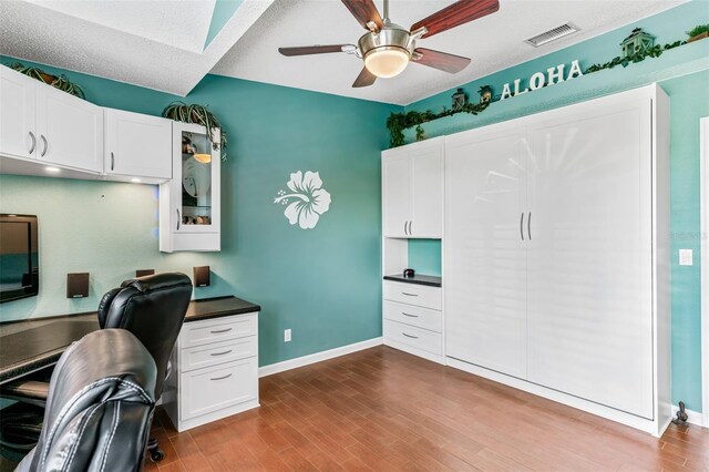 office space with wood-type flooring, a textured ceiling, and ceiling fan