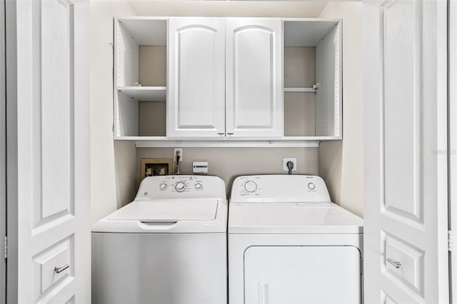 laundry room with cabinets and washing machine and dryer