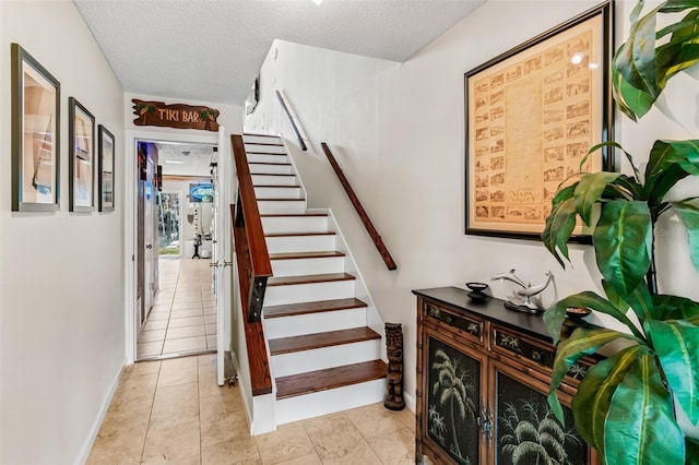 stairway with a textured ceiling