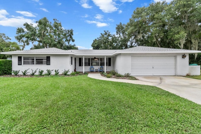 single story home featuring a garage and a front lawn