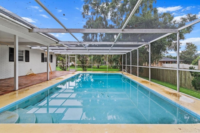 view of pool with a patio and glass enclosure