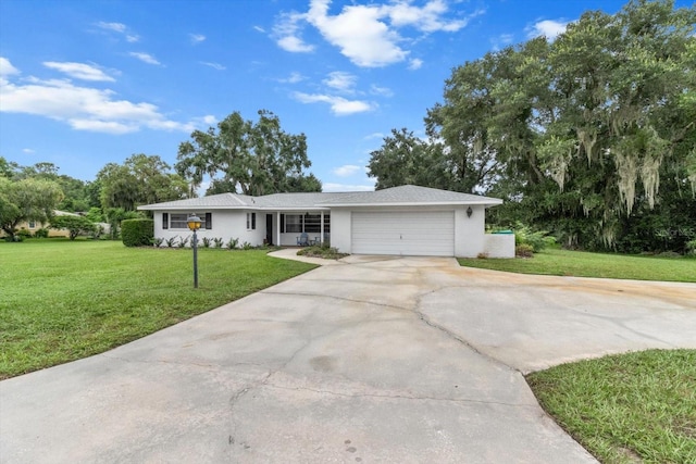 ranch-style house featuring a garage and a front yard