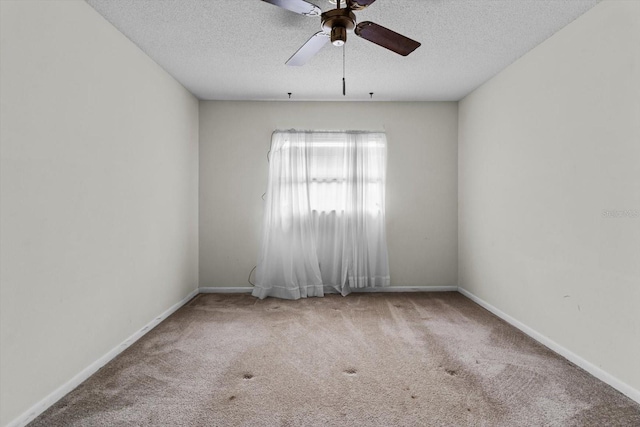 unfurnished room featuring ceiling fan, carpet floors, and a textured ceiling