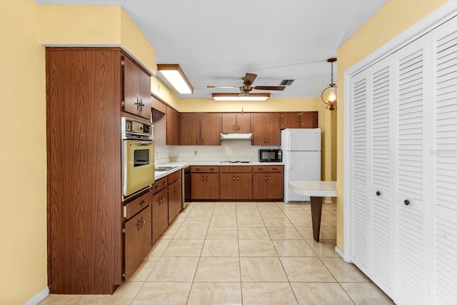 kitchen featuring ceiling fan, pendant lighting, white appliances, and light tile patterned floors