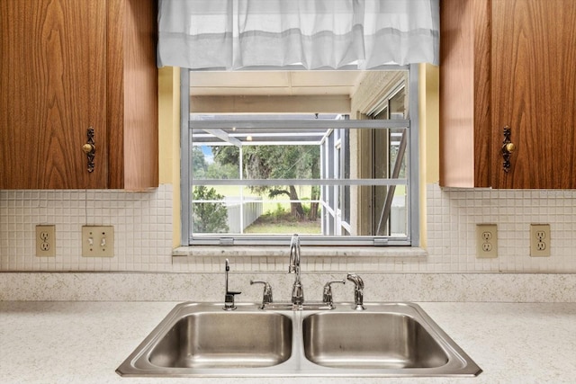 kitchen featuring tasteful backsplash and sink