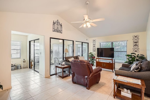 living room featuring light tile patterned flooring, ceiling fan, and high vaulted ceiling