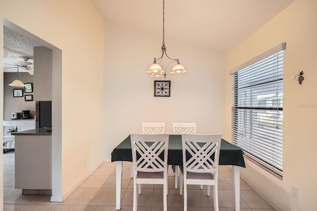 dining room with ceiling fan with notable chandelier and light tile patterned floors