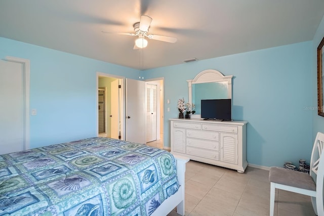 tiled bedroom featuring ceiling fan