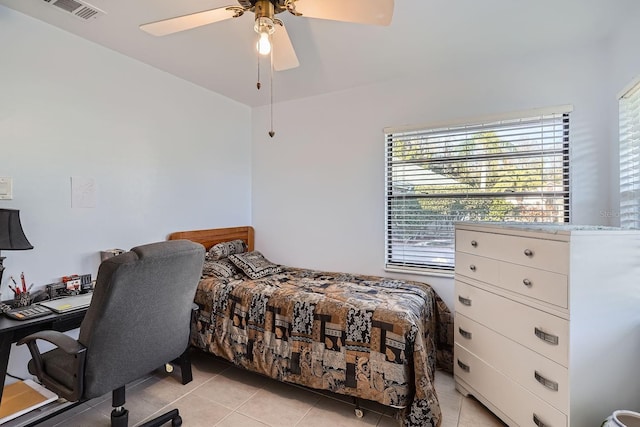 tiled bedroom with ceiling fan