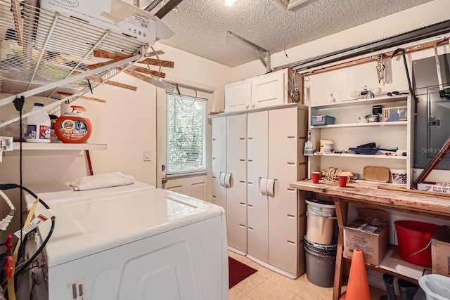 laundry room featuring cabinets and a textured ceiling