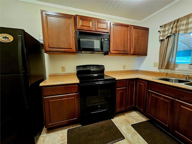 kitchen featuring crown molding, sink, and black appliances