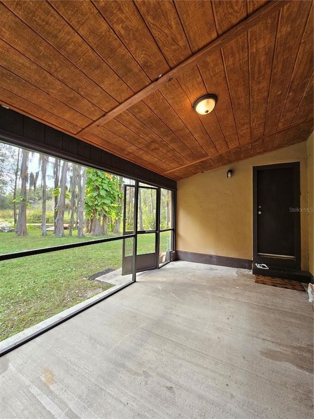 unfurnished sunroom featuring wooden ceiling