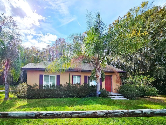 single story home featuring a front lawn