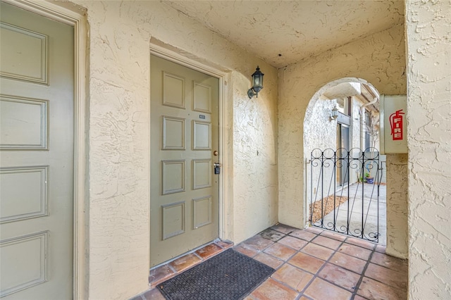 view of exterior entry featuring stucco siding