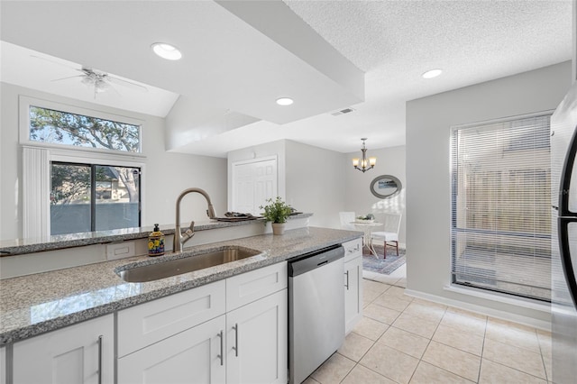 kitchen featuring white cabinetry, dishwasher, a sink, and light stone countertops