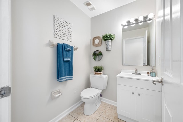 bathroom with visible vents, toilet, vanity, tile patterned flooring, and baseboards