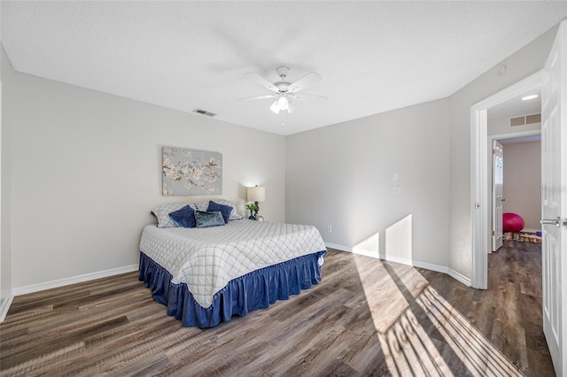 bedroom featuring dark wood-style floors, baseboards, and visible vents