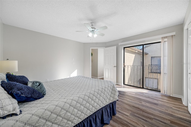 bedroom with access to exterior, a textured ceiling, a ceiling fan, and wood finished floors