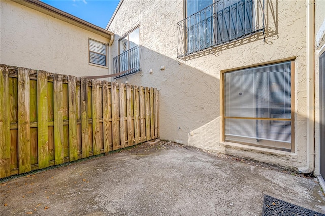 view of patio featuring fence