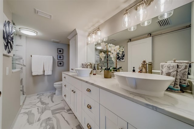 bathroom featuring vanity and toilet