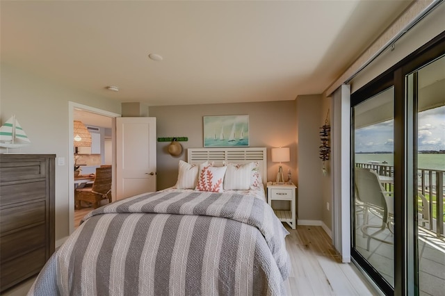 bedroom with access to outside and light hardwood / wood-style flooring