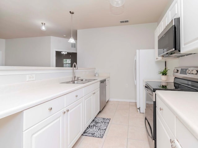 kitchen featuring light tile patterned flooring, sink, white cabinetry, appliances with stainless steel finishes, and pendant lighting