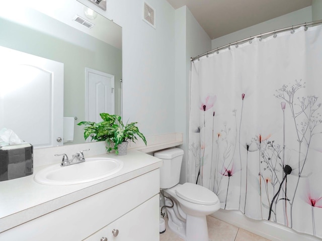 bathroom with tile patterned flooring, vanity, and toilet