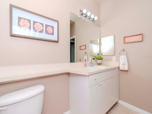 bathroom featuring vanity, toilet, and tile patterned flooring