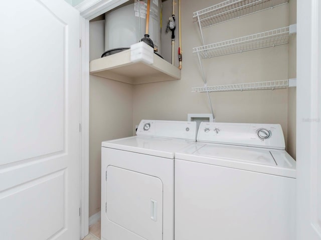 clothes washing area with washer and clothes dryer