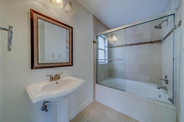 bathroom with tile patterned flooring and bath / shower combo with glass door