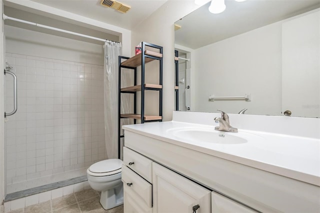 bathroom with tile patterned flooring, vanity, curtained shower, and toilet