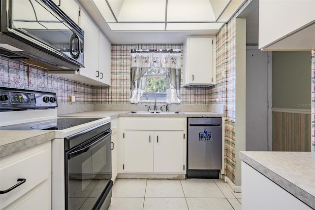 kitchen featuring sink, white cabinetry, black appliances, light tile patterned flooring, and decorative backsplash