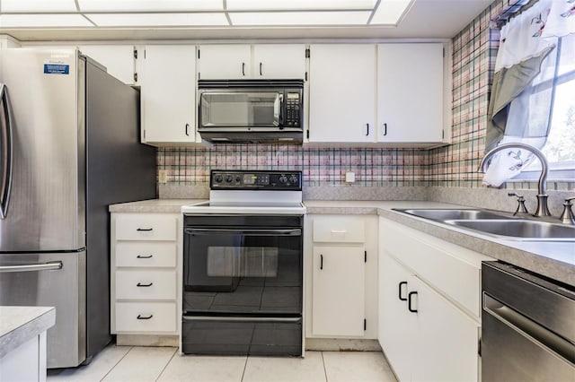 kitchen with tasteful backsplash, sink, black appliances, and white cabinets