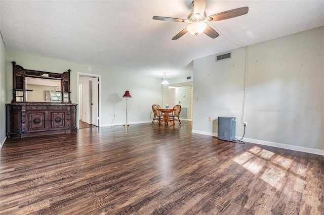 interior space featuring ceiling fan, dark hardwood / wood-style floors, and a textured ceiling