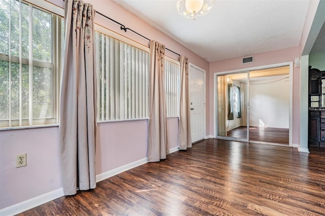 interior space featuring dark hardwood / wood-style flooring and a textured ceiling