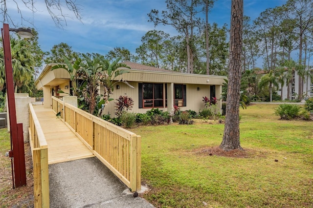 ranch-style home with a front yard and central air condition unit