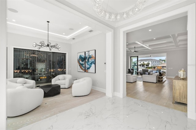 living room with coffered ceiling, a notable chandelier, beam ceiling, and ornamental molding