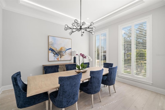 dining room with an inviting chandelier, crown molding, plenty of natural light, and light hardwood / wood-style floors