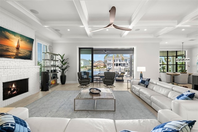 living room featuring coffered ceiling, crown molding, a fireplace, and beamed ceiling