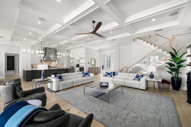 living room featuring coffered ceiling, sink, crown molding, light wood-type flooring, and beam ceiling